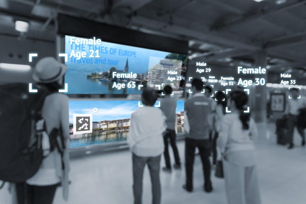 Digital Trends in signage, a group of people viewing a large wall screen